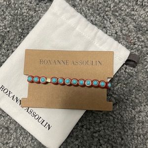 Roxanne Assoulin Enamel coated stretch bracelet with a gold tone logo